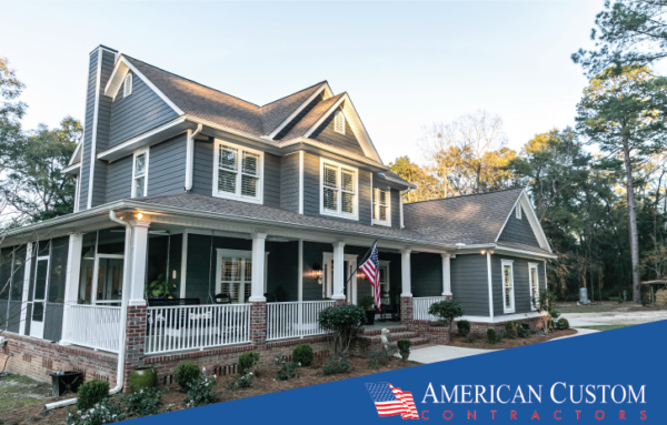 Picture of a colonial-style home with new gray cooling energy efficient vinyl siding and an American flag. The home is highlighted by a beautiful setting sunlight quality.