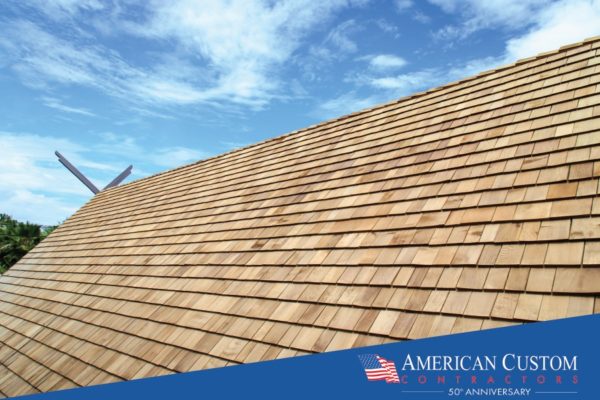 Picture of a natural cedar shake roof peak with a bright blue sky
