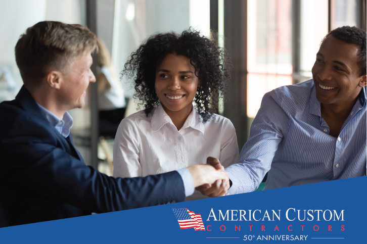 Homeowners shaking hands with their insurance adjuster after settling their roof claim