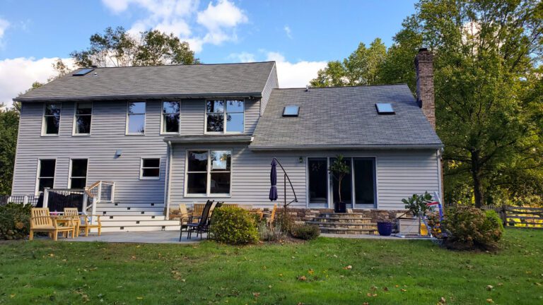 This split level home with 2 stories on the left side and double height single on the right features brand new gray Alside Vinyl Odessey Plus siding. The home is flooded with natural light through 3 curb mount Velux skylights and the many sash and sliders windows on the front and back of the home. The cute house is nestled amount 2 large trees and the lush green grass invites you to kick off your shoes and relax. American Custom Contractors did a great job with the siding and asphalt roof installs, the homeowner couldn't be happier.