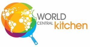 Logo of World Central Kitchen. It looks like a frying pan that is overlayed with rainbow colors and white bubbles in the shape of continents.
