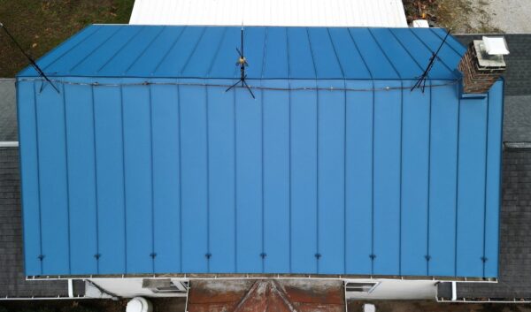 Drone photo of the top of a gallery blue custom standing seam.