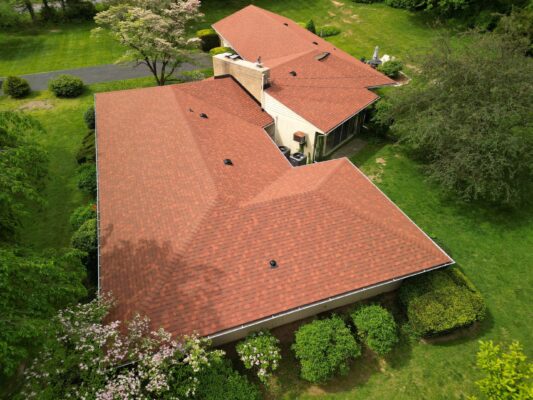 Drone photo of a home in Hagerstown, Maryland taken on a sunny day. Home is painted a creamy yellow and has a newly installed Owens Corning Terra Cotta roof shingle.