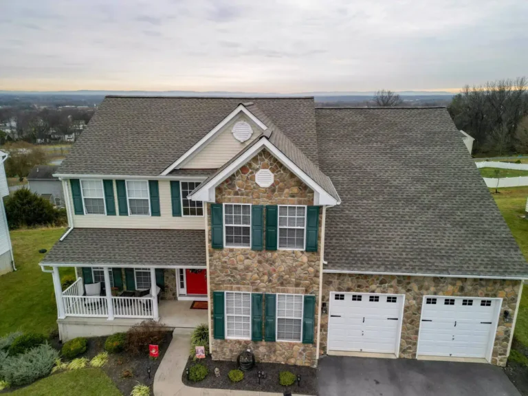 After picturing a a home in West Virginia faced with stone and tan colored vinyl siding.