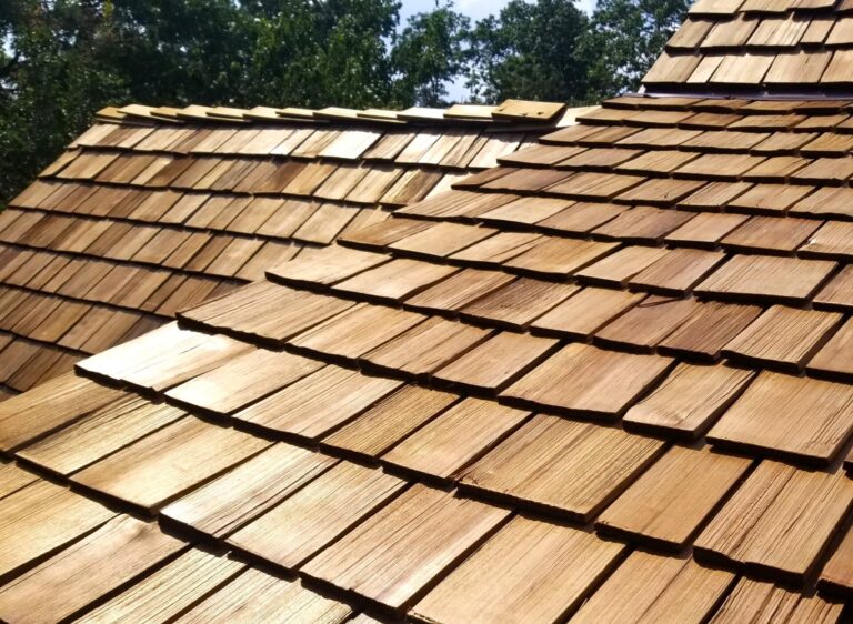 This is a photo of a newly installed natural cedar roof. The sun is shining on this warm tone shakes.