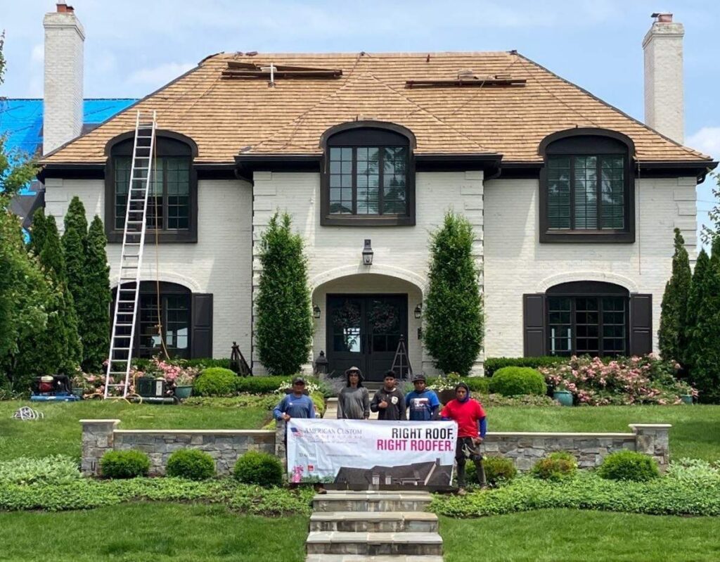 American Custom Contractors roofing crew standing in front of a completed home, representing skilled trade career opportunities in Rockville, MD.